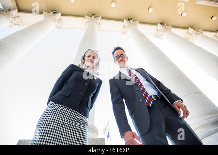 Low angle view of business people under columns Stock Photo