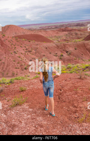 Caucasian girl walking on rural hilltop Stock Photo