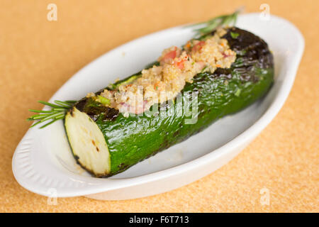 Grilled quinoa salad stuffed zucchini with rosemary Stock Photo