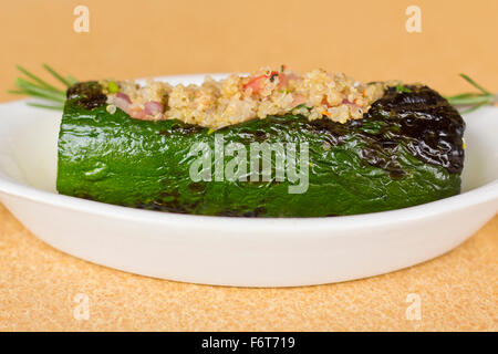 Grilled quinoa salad stuffed zucchini with rosemary Stock Photo