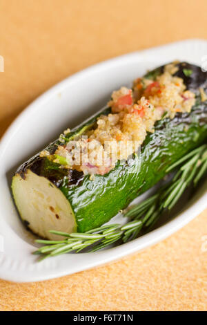 Grilled quinoa salad stuffed zucchini with rosemary Stock Photo