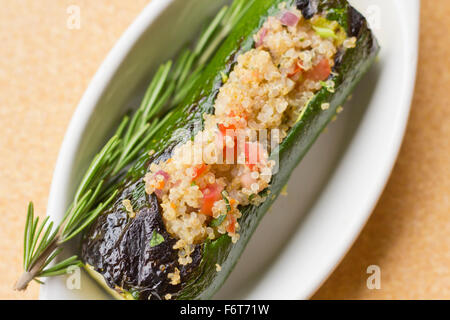 Grilled quinoa salad stuffed zucchini with rosemary Stock Photo
