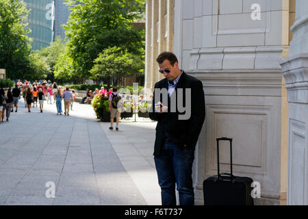 Man using smartphone. Near Wrigley Building, Chicago, Illinois. Stock Photo