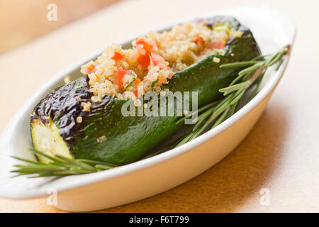 Grilled quinoa salad stuffed zucchini with rosemary Stock Photo