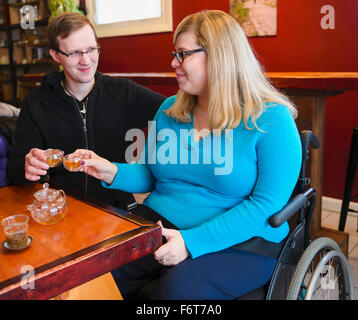 Paraplegic woman and boyfriend drinking tea Stock Photo