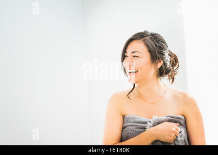 Laughing woman wrapped in towel Stock Photo