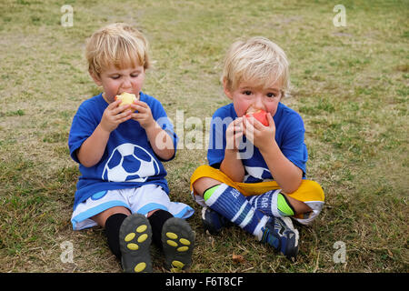 Caucasian soccer players eating apples Stock Photo