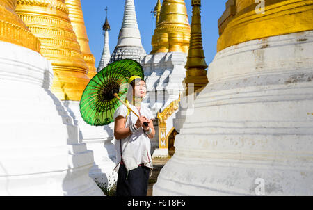 Asian woman carrying parasol at temple Stock Photo