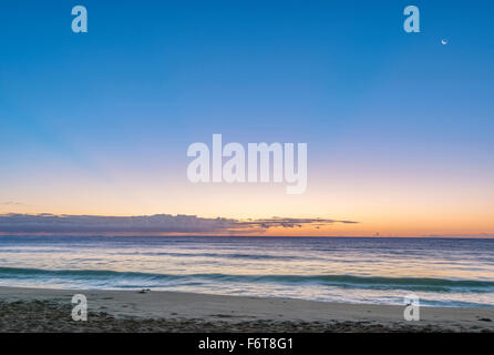 Sunrise over beach and ocean Stock Photo