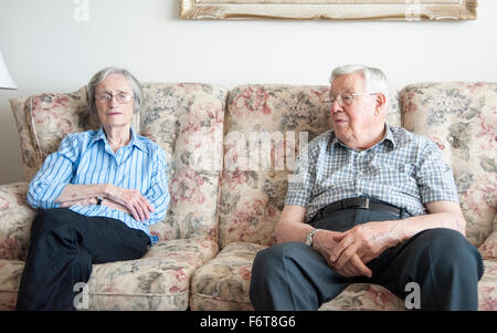 Couple sitting on sofa Stock Photo
