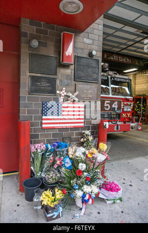 fresh flowers outside Engine 54 firehouse 8th Avenue honor the company's dead heroes extending from 1870 to 9/11/2001 & beyond Stock Photo