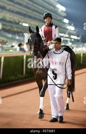 Meydan Racecourse, UAE. 19th November, 2015.   Richard Mullen with Last Fighter heading out for race 4 at Meydan Racecourse Credit:  Tom Morgan/Alamy Live News Stock Photo