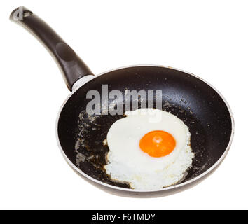 one fried egg in black frypan isolated on white background Stock Photo