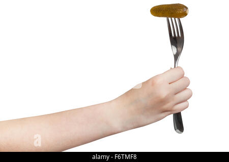 hand holds fork with impaled pickled gherkin isolated on white background Stock Photo