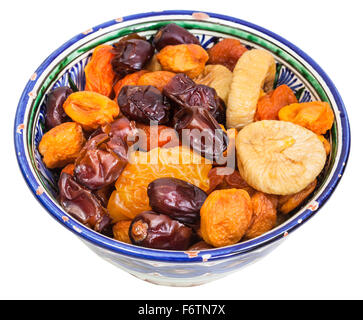 Central Asian dried fruits in traditional ceramic bowl isolated on white background Stock Photo