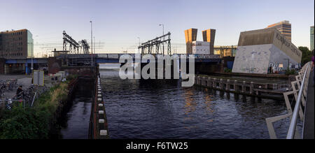 Panoramic view on the Piet Heinkade Bridge across the Oosterdok Canal at the sunset in Amsterdam (The Netherlands) Stock Photo