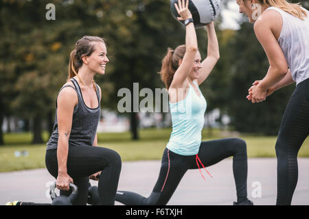 Three women having an outdoor boot camp workout