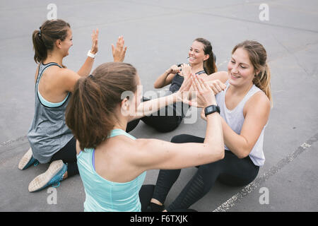 Four women having an outdoor boot camp workout