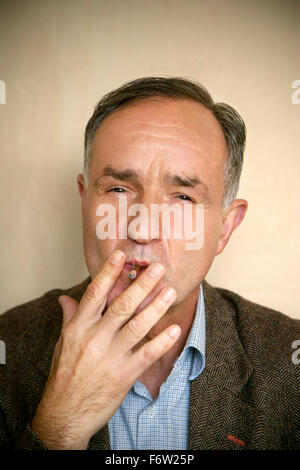 Portrait of man smoking cigarillo Stock Photo