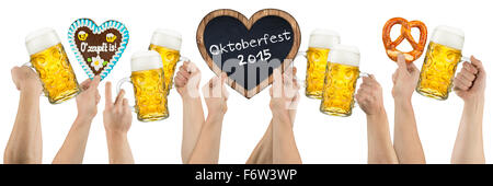 many hands holding german oktoberfest beer heart shaped gingerbread and blackboard on white background Stock Photo