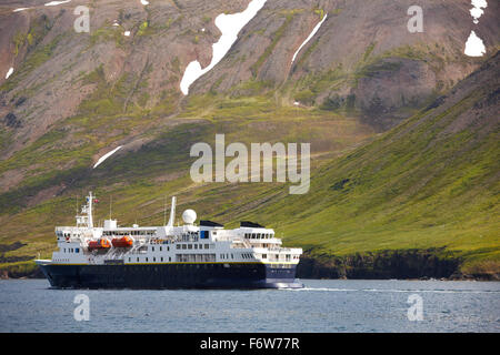 Passengers ferry on Siglufjordur fjord in the background Iceland Stock Photo