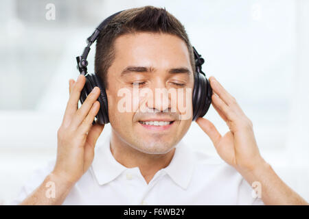 happy man in headphones listening to music at home Stock Photo