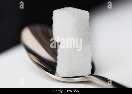 close up of white sugar cubes on teaspoon Stock Photo