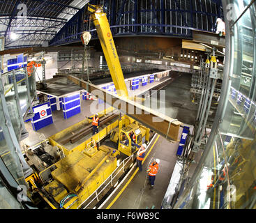 Overnight construction and renovation on London's Underground rail network. Temporary beams are erected at Earls Court Station. Stock Photo