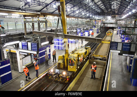 Overnight construction and renovation on London's Underground rail network. Temporary beams are erected at Earls Court Station. Stock Photo