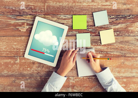 close up of hands with tablet pc and notebook Stock Photo
