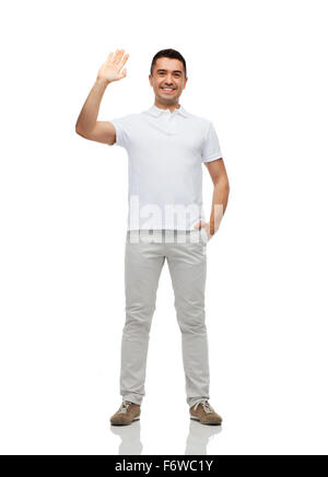 smiling man in blank white t-shirt waving hand Stock Photo
