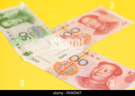 Chinese yuan banknotes on yellow background Stock Photo