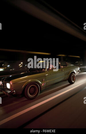 Man driving a modern classic car at night, Motoraver group, Hamburg, Germany Stock Photo