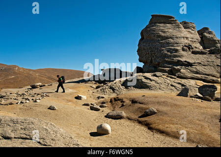 Man hiking at the rock formation of the Sphinx, Bucegi Mountains, Transylvania, Romania Stock Photo