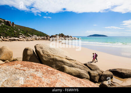 two-persons-walking-at-beach-