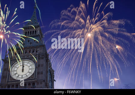 12 O'Clock in Big Ben, Fireworks are displayed on sky to celebrate new year. Stock Photo