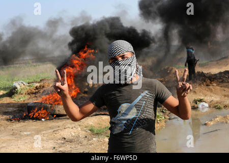 Gaza City, Gaza Strip, Palestinian Territory. 20th Nov, 2015. A Palestinian protester flashes victory sign during clashes with Israeli security forces near the border between Israel and eastern Gaza city, November 20, 2015. A series of attacks have been carried out by Palestinian individuals on Israeli military and civilians since the beginning of last month, leaving at least 86 Palestinians killed, many of whom were shot dead under circumstances in which rights groups said Israeli forces used unnecessary force Credit:  Mohammed Asad/APA Images/ZUMA Wire/Alamy Live News Stock Photo