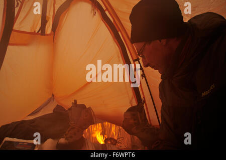 Cooking in a tent, base camp at Monte Sarmiento, Tierra del Fuego, Chile Stock Photo