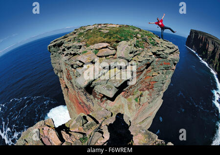 Climber on summit of the Old Man of Hoy, Orkney Islands, Scotland, Great Britain Stock Photo