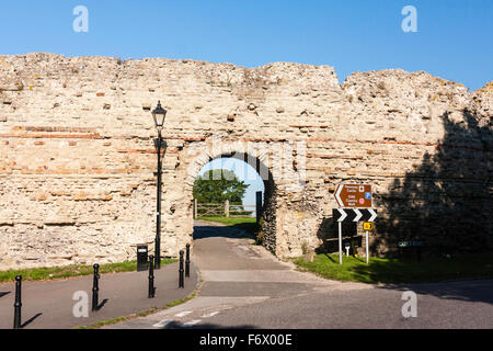 England, Pevensey. Roman Saxon Shore fort, castle. East gateway, circa 3rd to 4th century, and walls. Sight direction sign. Blue sky. Stock Photo