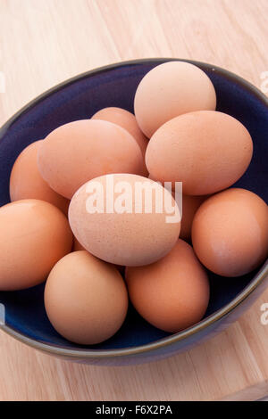 Raw brown eggs in a bowl Stock Photo