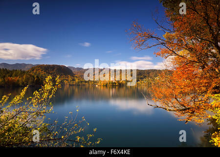 Bright sunny autumn day on Lake Bled in Slovenia with Mary Church. Long exposure. Stock Photo