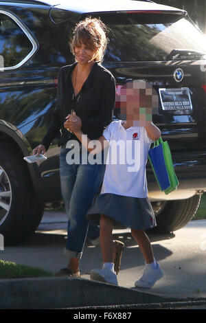 T.I., wearing a Clevland Cavaliers cap and Kobe Bryant Lower Merion  basketball jersey, out for a walk with his newborn daughter on a sunny day  in Beverly Hills Featuring: T.I., Heiress Harris