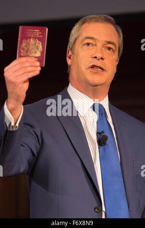 London, UK. 20 November 2015. Nigel Farage holds up his UK passport. Nigel Farage MEP, leader of the UK Independence Party (UKIP), speaks about a British exit of the European Union during the Say NO to the EU Tour at the Emmanuel Centre in London. Stock Photo