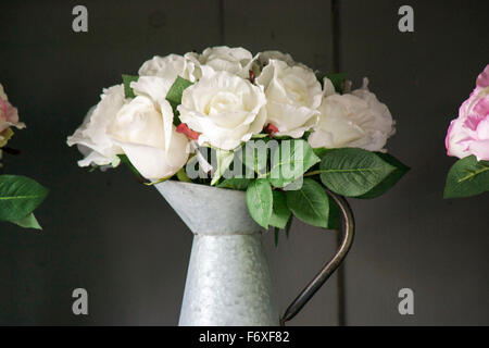 White roses in a jug ready for a wedding bouquet Stock Photo