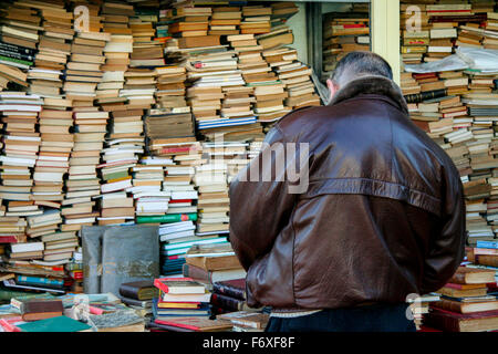 Man looking for old books for sale in the most famous flea market in Barcelona, also known as Els Encants Stock Photo