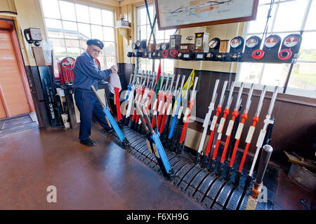 The signalman at work in Williton signalbox on the West Somerset Railway, England, UK Stock Photo