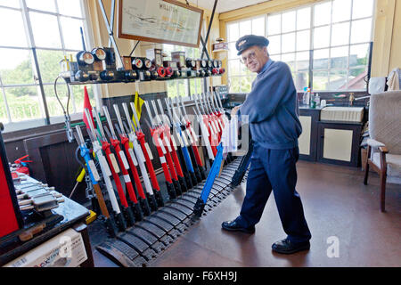 The signalman at work in Williton signalbox on the West Somerset Railway, England, UK Stock Photo