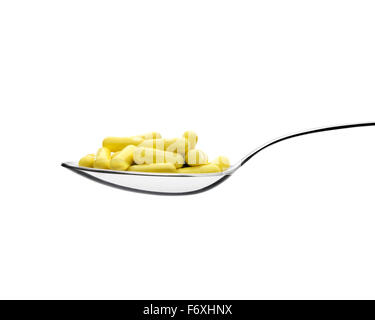 Spoon and pills front view. White background. Clipping path Stock Photo