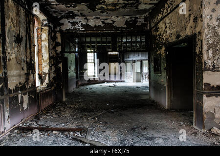 inside view of a deserted run down building after a fire Stock Photo